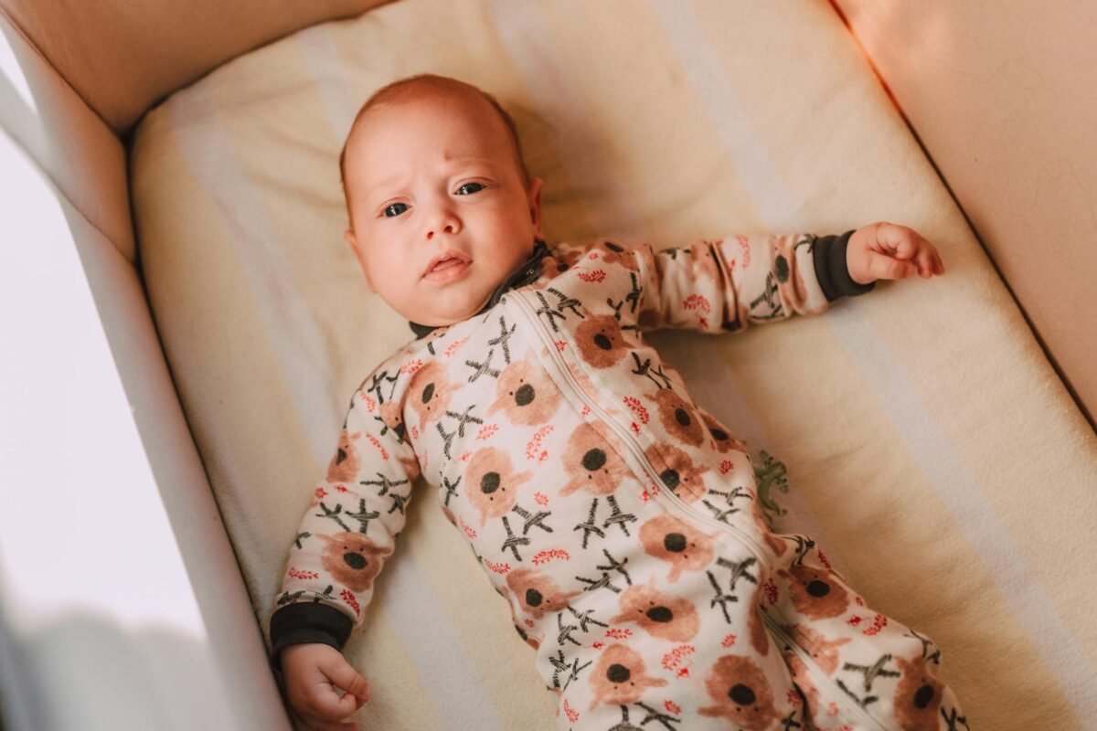 a baby lying in a crib
