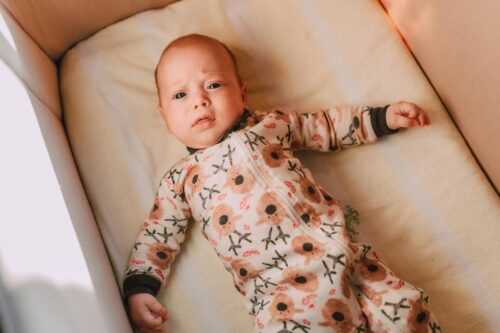 a baby lying in a crib